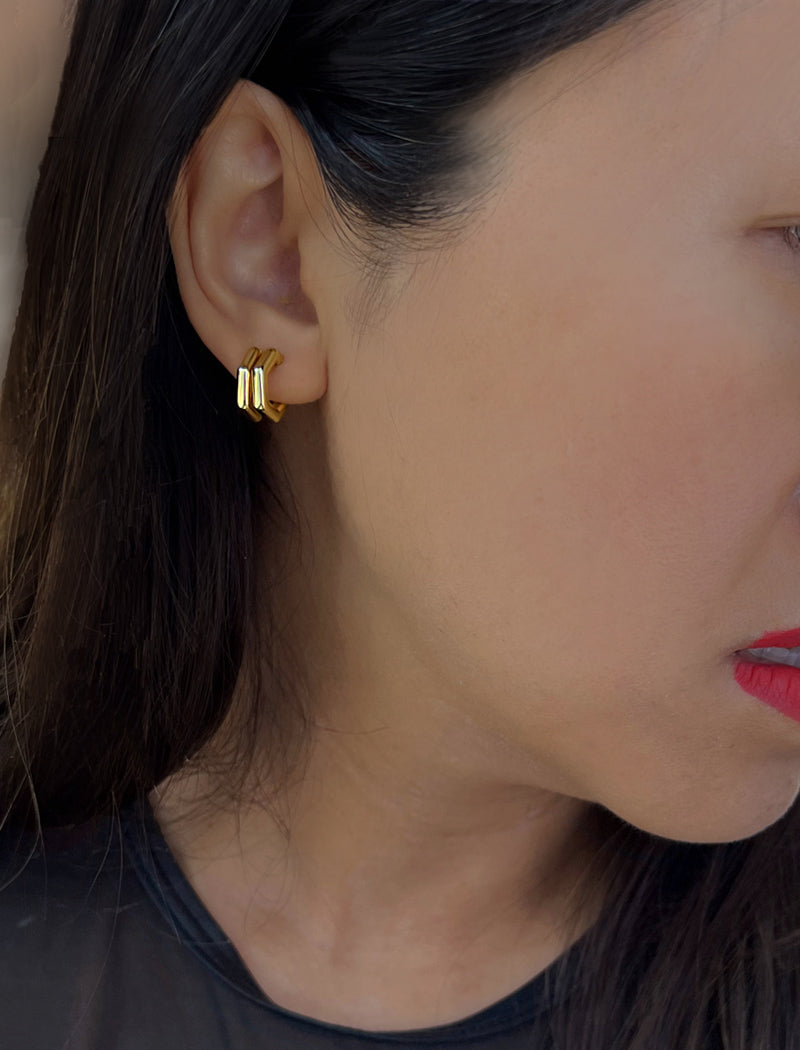 Female model wearing minimalist small chunky bold thick dainty stacking layering statement round FUTURISTIC Double Hexagon Huggie Hoop Earrings in 18K Gold Vermeil With 925 Sterling Silver base by Sonia Hou, a celebrity AAPI Chinese demi-fine jewelry designer
