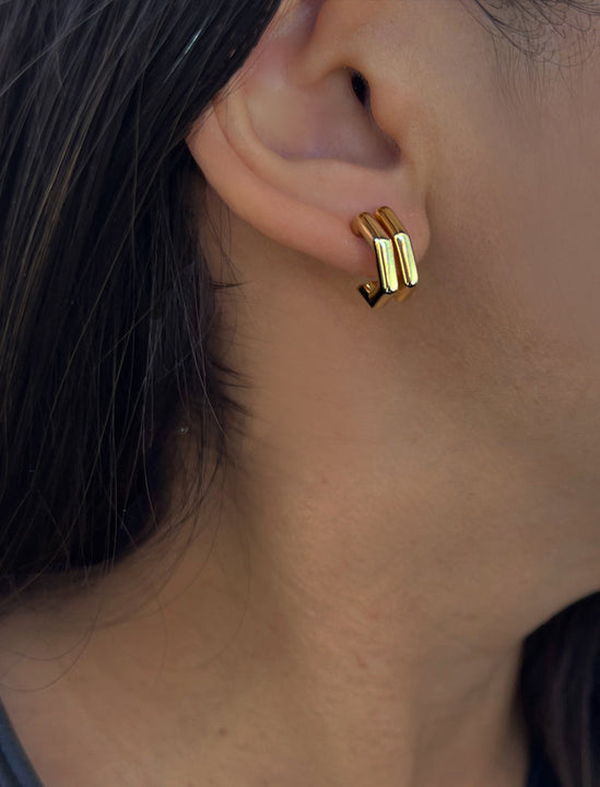 Female model wearing minimalist small chunky bold thick dainty stacking layering statement round FUTURISTIC Double Hexagon Huggie Hoop Earrings in 18K Gold Vermeil With 925 Sterling Silver base by Sonia Hou, a celebrity AAPI Chinese demi-fine jewelry designer