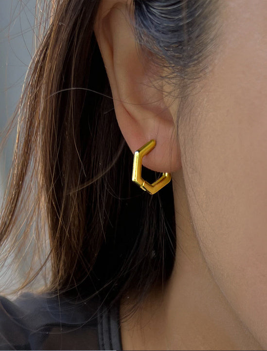Female model wearing minimalist mini tiny small chunky bold thick dainty stacking layering statement round INNOVATE Hexagon Huggie Hoop Earrings in 18K Gold Vermeil With 925 Sterling Silver base by Sonia Hou, a celebrity Asian AAPI Chinese demi-fine jewelry designer