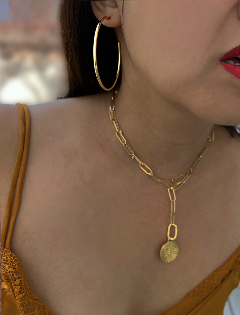 Female model wearing big medium large thin round circle PERFECT 50mm 2 inch hoop stacking lightweight everyday statement earrings in 18K Gold Vermeil With 925 Sterling Silver base by Sonia Hou, a celebrity AAPI Chinese demi-fine jewelry designer