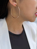 Female model wearing big medium large thin round circle PERFECT 50mm or 2 inch hoop stacking lightweight everyday statement earrings in 18K Rose Gold Vermeil With 925 Sterling Silver base by Sonia Hou, a celebrity AAPI Chinese demi-fine jewelry designer