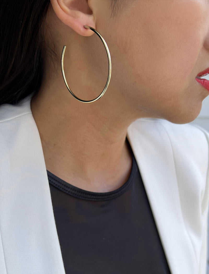 Female model wearing big medium large thin round circle PERFECT 50mm 2 inch hoop stacking lightweight everyday statement earrings in 925 Sterling Silver by Sonia Hou, a celebrity AAPI Chinese demi-fine jewelry designer