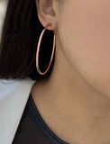 Female model wearing big medium large thin round circle PERFECT 50mm or 2 inch hoop stacking lightweight everyday statement earrings in 18K Rose Gold Vermeil With 925 Sterling Silver base by Sonia Hou, a celebrity AAPI Chinese demi-fine jewelry designer