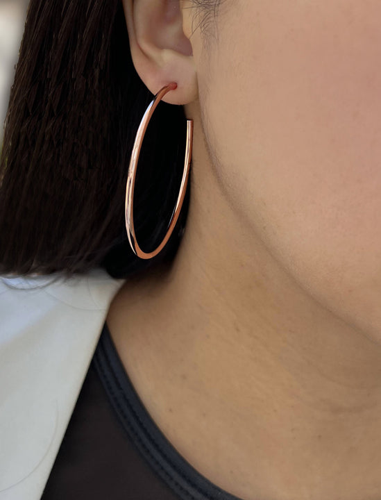 Female model wearing big medium large thin round circle PERFECT 50mm 2 inch hoop stacking lightweight everyday statement earrings in 18K Rose Gold Vermeil With 925 Sterling Silver base by Sonia Hou, a celebrity AAPI Chinese demi-fine jewelry designer
