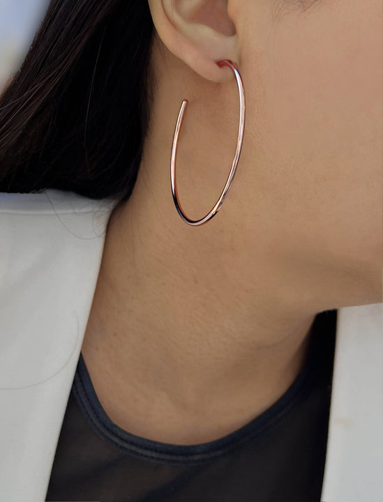 Female model wearing big medium large thin round circle PERFECT 50mm 2 inch hoop stacking lightweight everyday statement earrings in 18K Rose Gold Vermeil With 925 Sterling Silver base by Sonia Hou, a celebrity AAPI Chinese demi-fine jewelry designer