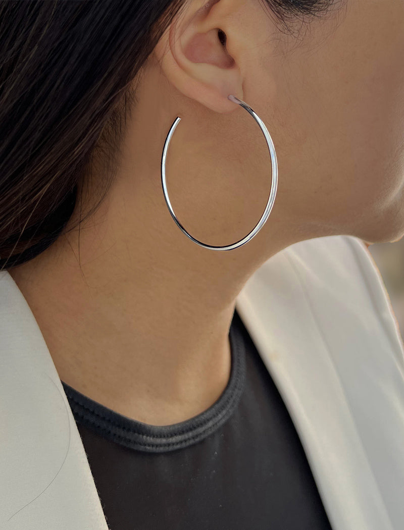 Female model wearing big medium large thin round circle PERFECT 50mm or 2 inch hoop stacking lightweight everyday statement earrings in 18K Gold Vermeil With 925 Sterling Silver base by Sonia Hou, a celebrity AAPI Chinese demi-fine jewelry designer