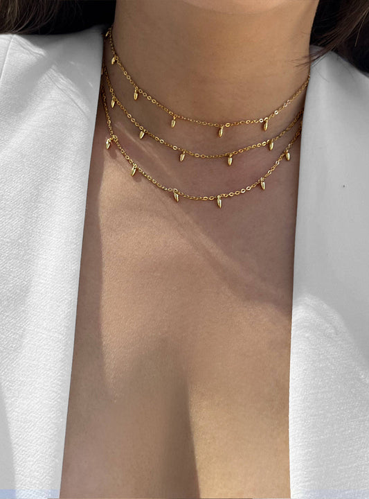 Female model wearing inclusive Asian inspired thin Rice bead minimalist chain layering stacking necklace in 18K gold vermeil with a 925 sterling silver base by Sonia Hou, a celebrity Chinese AAPI demi-fine jewelry designer