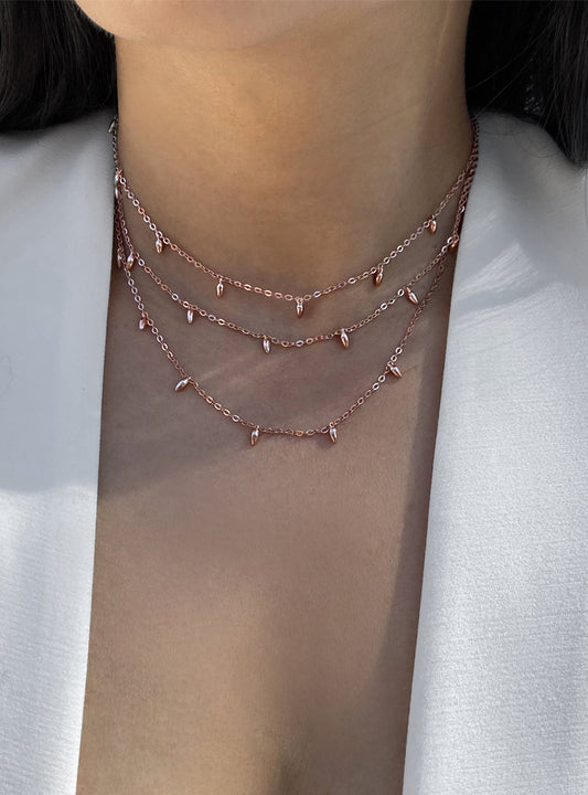 Female model wearing inclusive Asian inspired thin Rice bead minimalist chain layering stacking necklace in 18K rose gold vermeil with sterling silver base by Sonia Hou, a celebrity Chinese AAPI demi-fine jewelry designer