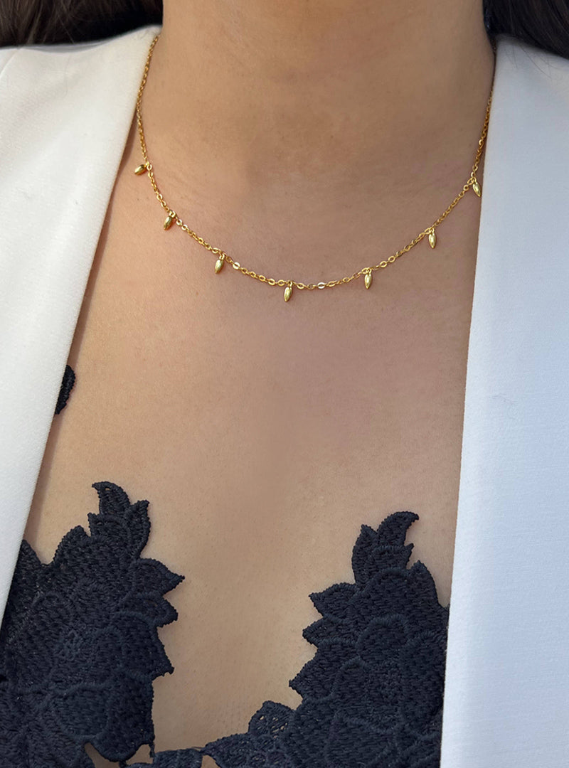 Female model wearing inclusive Asian inspired thin Rice bead minimalist chain layering stacking necklace in 18K gold vermeil with sterling silver base by Sonia Hou, a celebrity Chinese AAPI demi-fine jewelry designer