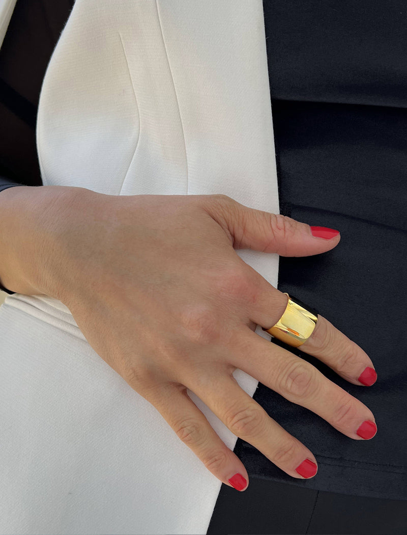 Female model wearing wide RICH thick bold chunky statement cigar band ring in 18K gold vermeil with a 925 sterling silver base by Sonia Hou, a celebrity AAPI Chinese demi-fine jewelry designer