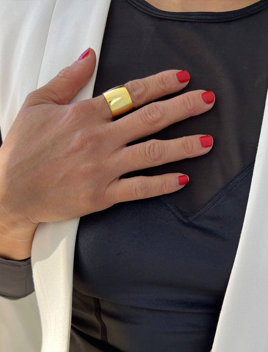Female model wearing wide  RICH thick bold chunky statement cigar band ring in 18k gold vermeil with 925 sterling silver base by Sonia Hou, a celebrity AAPI Chinese demi-fine jewelry designer
