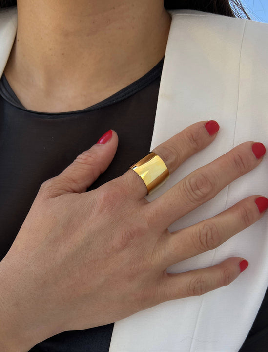 Female model wearing RICH wide thick bold chunky statement cigar band ring in 18k gold vermeil with 925 sterling silver base by Sonia Hou, a celebrity AAPI Chinese demi-fine jewelry designer