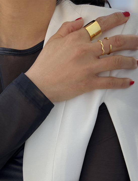 Female model wearing wide RICH thick bold chunky statement cigar band ring in 18K gold vermeil with a 925 sterling silver base by Sonia Hou, a celebrity AAPI Chinese demi-fine jewelry designer