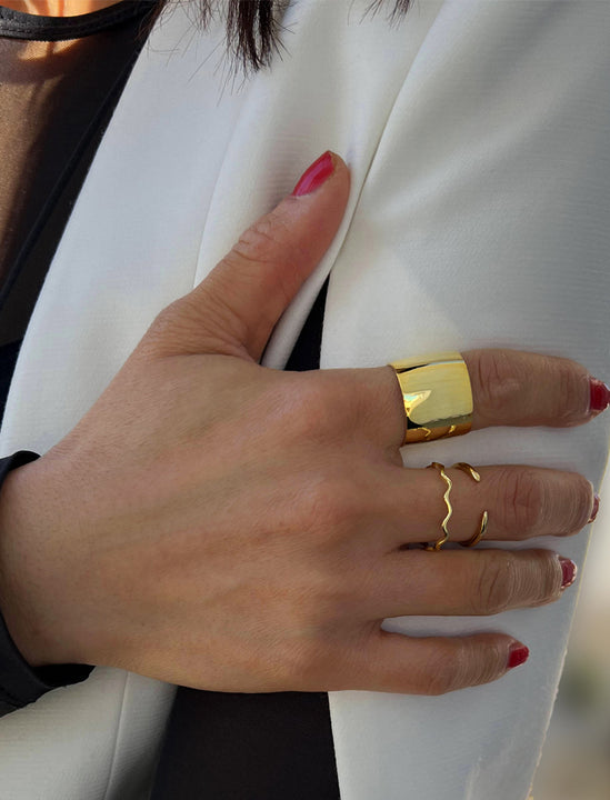 Female model wearing wide RICH thick bold chunky statement cigar band ring in 18K gold vermeil with a 925 sterling silver base by Sonia Hou, a celebrity AAPI Chinese demi-fine jewelry designer