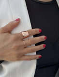 Female model wearing wide RICH thick bold chunky statement cigar band ring in 18k rose gold vermeil with 925 sterling silver base by Sonia Hou, a celebrity AAPI Chinese demi-fine jewelry designer