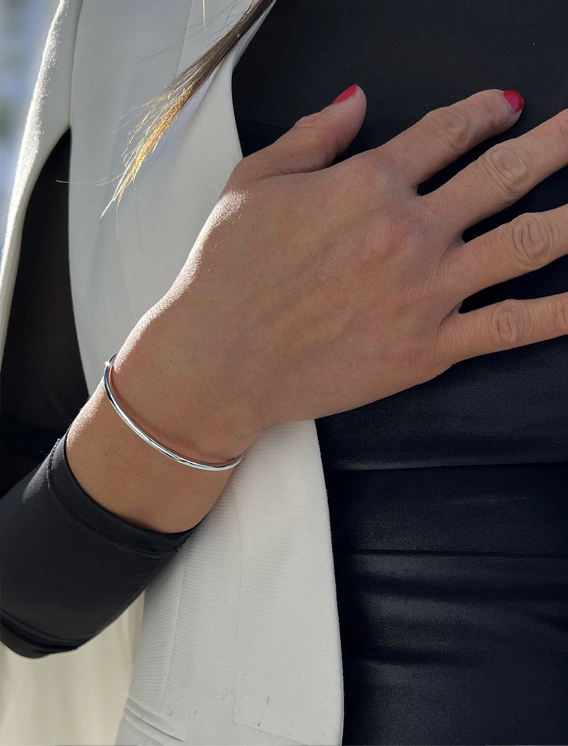 Female model wearing adjustable minimalist simple Success Thin Cuff Chunky Bold Layering Stacking Statement 2 Way convertible Bangle Cuff Open Bracelet in 925 sterling silver by Sonia Hou, a celebrity AAPI Chinese demi-fine fashion costume jewelry designer