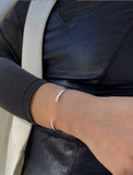 Female model wearing adjustable minimalist simple Success Thin Cuff Chunky Bold Layering Stacking Statement 2 Way convertible Bangle Cuff Open Bracelet in 925 sterling silver by Sonia Hou, a celebrity AAPI Chinese demi-fine fashion costume jewelry designer