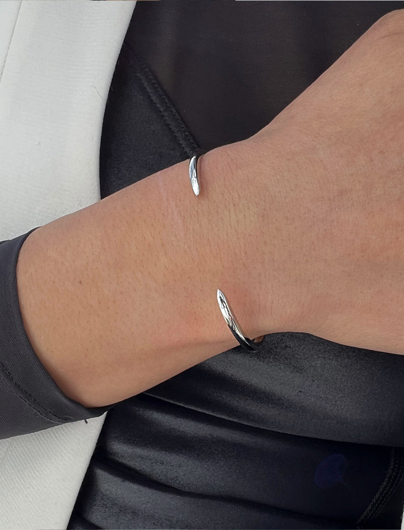 Female model wearing adjustable minimalist simple Success Thin Cuff Chunky Bold Layering Stacking Statement 2 Way convertible Bangle Cuff Open Bracelet in 925 sterling silver by Sonia Hou, a celebrity AAPI Chinese demi-fine fashion costume jewelry designer