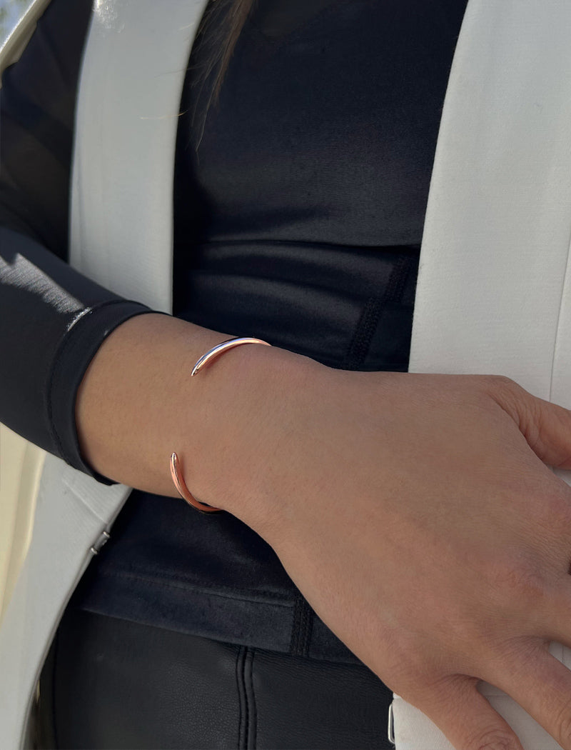 Female model wearing adjustable minimalist simple Success Thin Cuff Chunky Bold Layering Stacking Statement 2 Way convertible Bangle Cuff Open Bracelet in 18K Rose Gold Vermeil with 925 sterling silver base by Sonia Hou, a celebrity AAPI Chinese demi-fine fashion costume jewelry designer