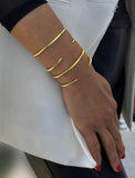 Female model wearing adjustable minimalist simple Success Thin Cuff Chunky Bold Layering Stacking Statement 2 Way convertible Bangle Cuff Open Bracelet in 18K Gold Vermeil with 925 sterling silver base by Sonia Hou, a celebrity AAPI Chinese demi-fine fashion costume jewelry designer