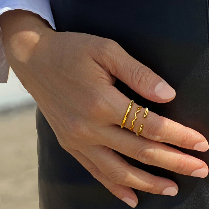 Female model wearing adjustable minimalist Success Simple Midi Thick Chunky Thin Bold Layering Stacking Statement 2 Way Convertible Band Open Ring in 18K Gold Vermeil with sterling silver base by Sonia Hou, a celebrity AAPI Chinese demi-fine fashion costume jewelry designer